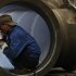 An employee welds a water turbine at a factory in Jinhua, Zhejiang province