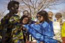 A Tuareg child pushes away a Bella girl at a camp for Malian refugees in Goudebou