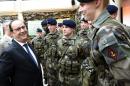 French President Francois Hollande speaks to young soldiers as he visits the military school of Saint-Cyr-Coëtquidan in Guer before delivering New Year's wishes to French Army in Guer, western France, Thursday, Jan. 14, 2016. (Damien Meyer, Pool photo via AP)