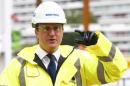 Britain's Prime Minister David Cameron points during a visit to a construction site in central London
