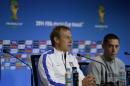United States' head coach Jurgen Klinsmann, left, speaks flanked by attacker Clint Dempsey during a press conference the day before the World Cup round of 16 soccer match between Belgium and the U.S. at Arena Fonte Nova in Salvador, Brazil, Monday, June 30, 2014. (AP Photo/Julio Cortez)