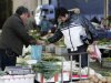 A man buys vegetables at a market Friday Dec. 9, 2011 in Shanghai, China. China's chronically high inflation rate fell to a lower than expected 4.2 percent in November, allowing wider leeway for Beijing to ease credit to support growth. (AP Photo)