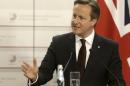 Britain's Prime Minister Cameron gestures as he speaks at a news conference after the Eastern Partnership Summit in Riga