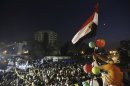 A boy holds an Egyptian flag together with members of the Muslim Brotherhood and supporters of Mursi at the Rabaa Adawiya square