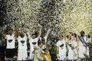 Real Madrid's basketball player Felipe Reyes, center, embraces Spanish King Felipe after receiving the winner's trophy of the Euroleague Final Four Championship basketball match between Real Madrid and Olympiacos in Madrid, Spain, Sunday, May 17, 2015. (AP Photo/Daniel Ochoa de Olza)