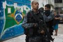 Militarized police commandos patrol the Praia da Ramos and Roquette Pinto communities, part of the Mare shantytown in Rio de Janeiro, Brazil, on April 1, 2015