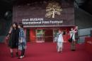 People gather near the entrance of the main venue of the Busan International Film Festival (BIFF)