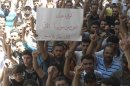 Demonstrators protest against Syria's President Bashar al-Assad after Friday Prayers in Houla near Homs