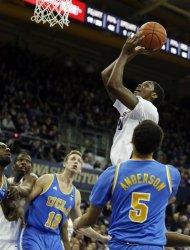 Washington's Jernard Jarreau puts up a shot above UCLA's David Wear (12) and Kyle Anderson (5) during the first half of an NCAA college basketball game, Saturday, March 9, 2013, in Seattle. (AP Photo/Ted S. Warren)