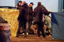 Italian police and forensics experts gather around the body of suspected Berlin truck attacker Anis Amri after he was shot dead in Milan on December 23, 2016