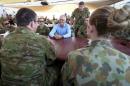 Australian Prime Minister Malcolm Turnbull (C) talks with Australian troops during breakfast at Camp Baird, located in the Middle East, during his visit to Iraq
