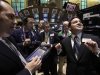 FILE - In a March 21, 2012 file photo, Specialist Paul Cosentino, right, directs trading on the floor of the New York Stock Exchange. Stocks closed mostly lower Tuesday Aug. 14, 2012, after trading slightly higher for much of the day.    (AP Photo/Richard Drew,file)