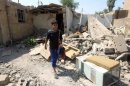 Eleven-year-old Mohammed searches for salvageable items amid the rubble of his family's destroyed house