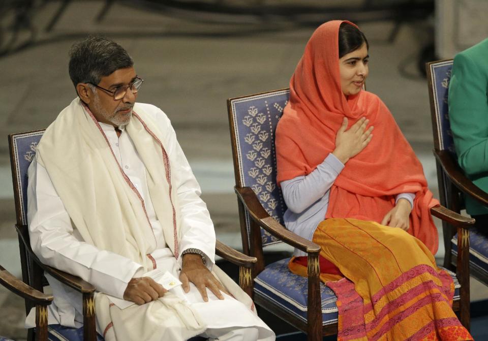 Nobel Peace Prize winners Malala Yousafzai from Pakistan, right, and Kailash Satyarthi of India take their seats during the Nobel Peace Prize award...