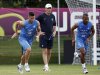 France's soccer players Giroud and Malouda run in front of coach Blanc during a training session at the team's training center in Kircha near Donetsk