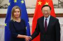 EU foreign policy chief Federica Mogherini (L) shakes hands with China's State Councilor Yang Jiechi in Beijing on May 5, 2015