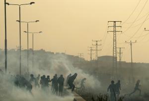 Palestinian protesters run from tear gas during clashes&nbsp;&hellip;