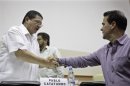 FARC negotiator Catatumbo shake hands with Colombia's government negotiator Pearl during a conference in Havana