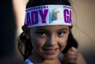 A Lady Gaga fan smiles for a photo as she stands outside, waiting to enter the stadium where the U.S. pop star will perform a concert, in Buenos Aires, Argentina, Friday, Nov. 16, 2012. The Latin American leg of her, "Born This Way Ball Tour," is coming to an end but not before stopping in Chile, Peru and Paraguay. (AP Photo/Natacha Pisarenko)
