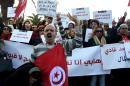 Tunisians demonstrate outside parliament in Tunis on December 24, against allowing Tunisians who joined the ranks of jihadist groups to return to the country