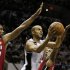 Spurs' Parker drives to the net between Heat's Bosh and Chalmers during Game 3 of their NBA Finals basketball playoff in San Antonio