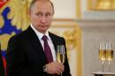Russia's President Putin holds a glass during a ceremony of receiving diplomatic credentials from foreign ambassadors at the Kremlin in Moscow