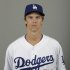 This is a 2013 photo of Los Angeles Dodgers pitcher Zack Greinke. This image reflects the Los Angeles Dodgers baseball team active roster when this image was taken in Phoenix, Sunday, Feb. 17, 2013.  Greinke was scratched from his spring training start for the Dodgers on Monday March 11, 2013, against Milwaukee and went to Los Angeles to have his sore right elbow examined. Greinke, signed to a $147 million, six-year contract in December as a free agent, threw a bullpen session Friday without issue, then felt discomfort while throwing Sunday.  (AP Photo/Paul Sancya)