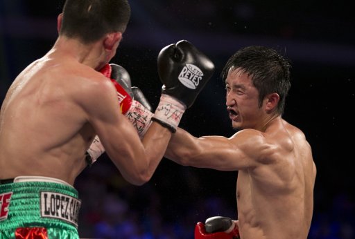 China's Zou Shiming, right, fights against Mexico's Jesus Ortega during their Flyweight Bout at the Cotai Arena in Venetian Macao in Macau, China, Saturday July 27, 2013