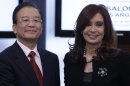 China's Premier Wen Jiabao, left, and Argentine President Cristina Fernandez pose for a picture after signing bi-lateral agreements at the government house in Buenos Aires, Argentina, Monday, June 25, 2012. (AP Photo/Natacha Pisarenko)