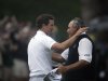 Adam Scott, left, of Australia, is congratulated by Angel Cabrera, of Argentina, after making a birdie putt on the second playoff hole to win the Masters golf tournament Sunday, April 14, 2013, in Augusta, Ga. (AP Photo/Charlie Riedel)