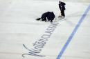Members of the ice crew works on the playing surface during the 2012 NHL Winter Classic at Citizens Bank Park on January 2, 2012 in Philadelphia, Pennsylvania