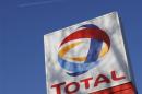 A logo for oil giant Total is seen at a petrol station in London