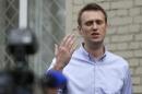 Opposition leader Alexei Navalny talks to media after leaving justice court building in Moscow