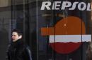 A man walks past a petrol station owned by Spanish oil major Repsol in central Madrid