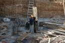 A Palestinian worker is seen on a construction site in the east Jerusalem neighborhood of Ramat Sholmo, Tuesday, Dec. 18, 2012. A European diplomat says Germany and three other European members of the U.N. Security Council are preparing a statement condemning Israel's latest settlement plans in the West Bank.(AP Photo/Dan Balilty)