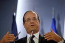 France's President Hollande gestures during a news conference in Madrid
