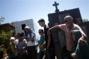 Relatives of Paula Simone Melo Prates, who died during the fire at Boate Kiss nightclub, attend her funeral in the southern city of Santa Maria