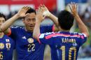 Japan's Maya Yoshida celebrates after scoring a goal with teammate Shinji Kagawa, right, during the AFC Asia Cup soccer match between Japan and Palestine in Newcastle, Australia, Monday, January 12, 2014. (AP Photo/Rob Griffith)