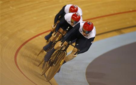 Britain's Philip Hindes, Chris Hoy and Jason Kenny compete in the track cycling men's team sprint qualifying heats at the Velodrome during the London 2012 Olympic Games