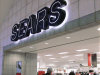 In this Nov. 15, 2011 photo, customers enter a Sears store, in Springfield, Ill. Sears Holdings Corp.’s third-quarter loss widened, dragged down by weakness in Canada, declining consumer electronics sales and softer clothing sales at its Kmart stores.  (AP Photo/Seth Perlman)