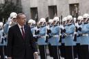 Turkey's President Recep Tayyip Erdogan inspects a military honour guard as he arrives to address the parliament in Ankara, Turkey, Saturday, Oct. 1, 2016. Erdogan hinted on Thursday that the three-month state of emergency declared following the failed July 15 coup could be extended to over a year. (AP Photo/Burhan Ozbilici)