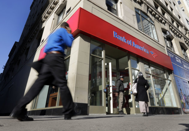 People pass a Bank of America brach, in New York, Monday, Jan. 7, 2013. Bank of America will pay $10.3 billion to the government mortgage agency Fannie Mae to settle claims resulting from mortgage-backed investments that soured during the housing crash. (AP Photo/Richard Drew)
