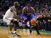 New York Knicks' Anthony drives to the basket around Boston Celtics' Garnett during their NBA basketball game in Boston