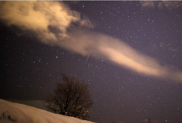 A meteor streaks past stars …