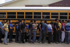 Deportees line up for a bus at care center after arriving&nbsp;&hellip;