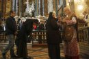 Boston Cardinal Sean O'Malley gives communion while leading mass at the Santa Maria Della Vittoria church in Rome