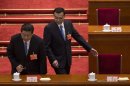 Chinese President Xi Jinping, left, and Premier Li Kiqiang, right, get to their seats during a plenary session of the NPC held in Beijing's Great Hall of the People, China, Saturday, March 16, 2013. China's new leaders turned Saturday to veteran technocrats with greater international experience to staff a Cabinet charged with overhauling a slowing economy and pursuing a higher global profile without triggering opposition. (AP Photo/Alexander F. Yuan)