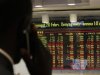 A stockbroker transacts shares during a trading session at the Nairobi Securities Exchange in Nairobi