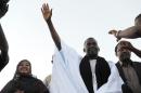 Mauritania anti-slavery activist Biram Dah Abeid waves at supporters as he takes part in a campaign rally on the last day of the national presidential election campaign, in Nouackchott, on June 19, 2014