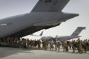 FILE -- In this Thursday, July 14, 2011 file photo, U.S. soldiers board a U.S. military plane, as they leave Afghanistan, at the U.S. base in Bagram north of Kabul, Afghanistan. The United States is not alone in pulling combat troops off the Afghan battlefield. More than a dozen other countries have draw down plans that combined with the U.S. withdrawal will shrink the foreign military footprint in Afghanistan by more than 40,000 troops by the close of next year. (AP Photo/Musadeq Sadeq, File)